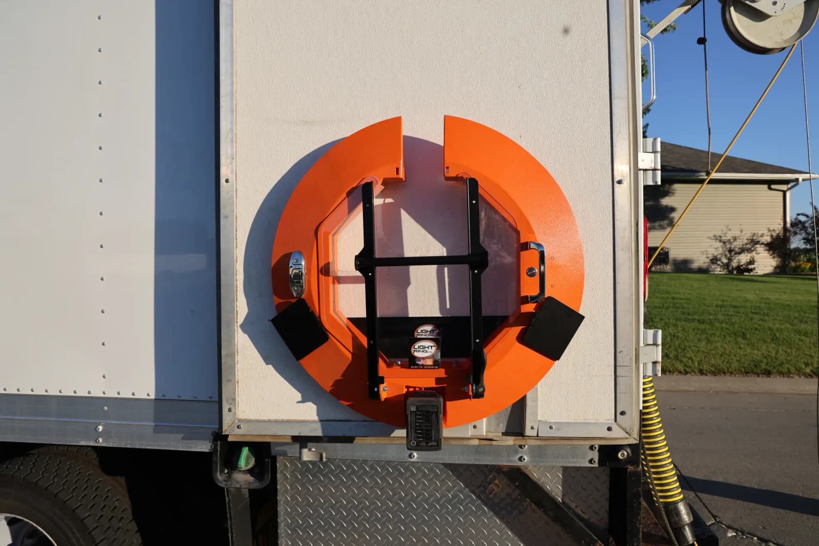 Orange Light Ring stored vertically on the side of a white inspection truck.