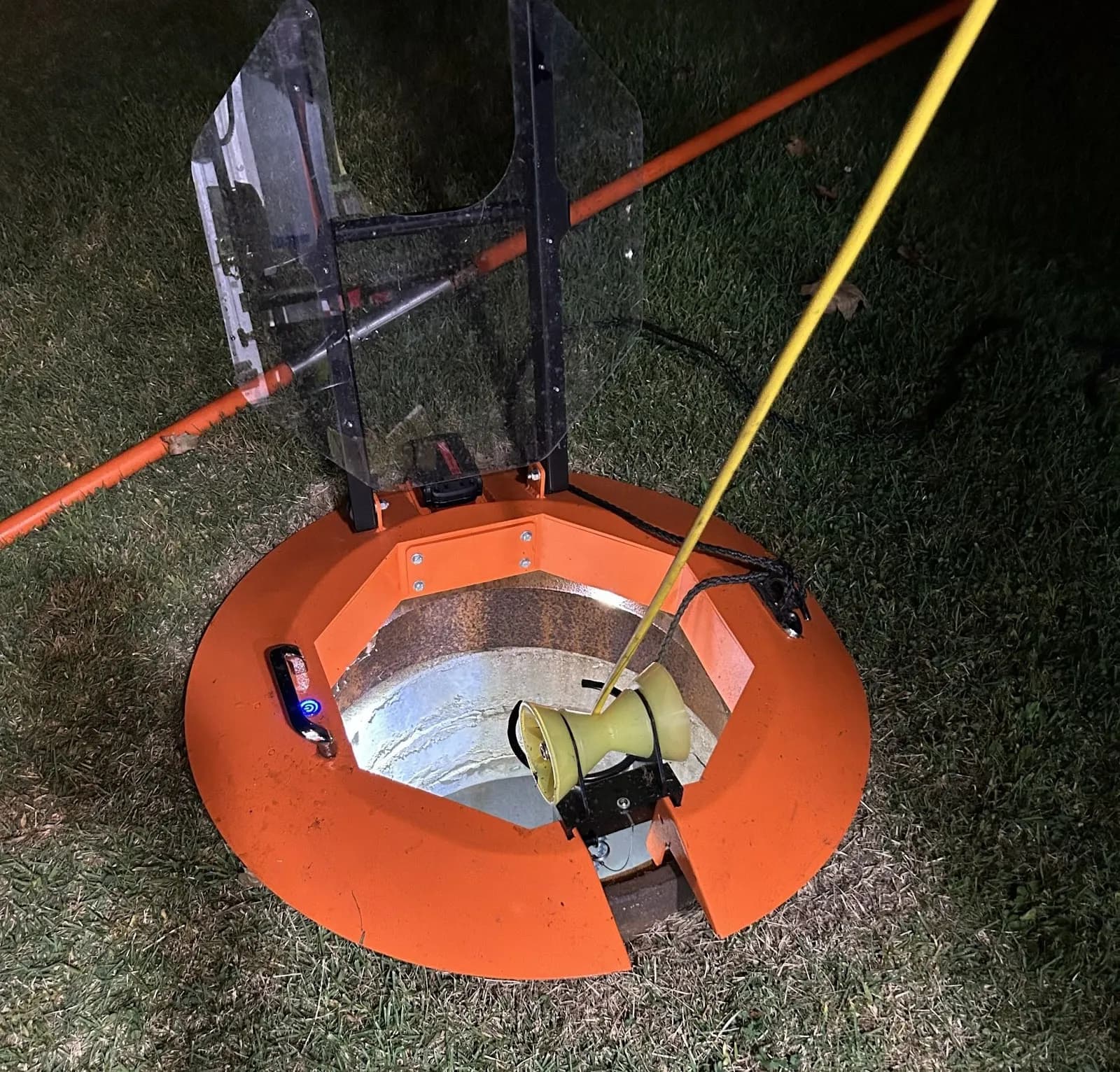 Light Ring with its cover raised and a yellow line passing over the roller in low light.