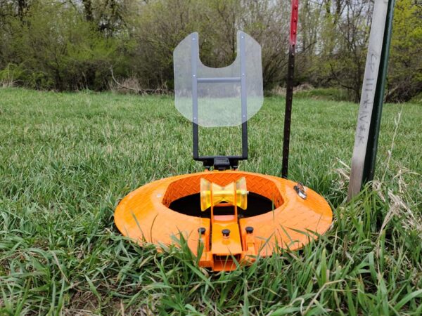 The Light Ring shown on grass during the day with he safety cover flipped up.