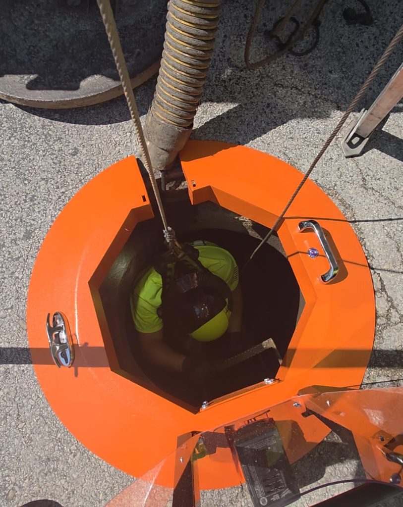 Light Ring aluminum frame deployed on a manhole rim as a structural fall barrier.