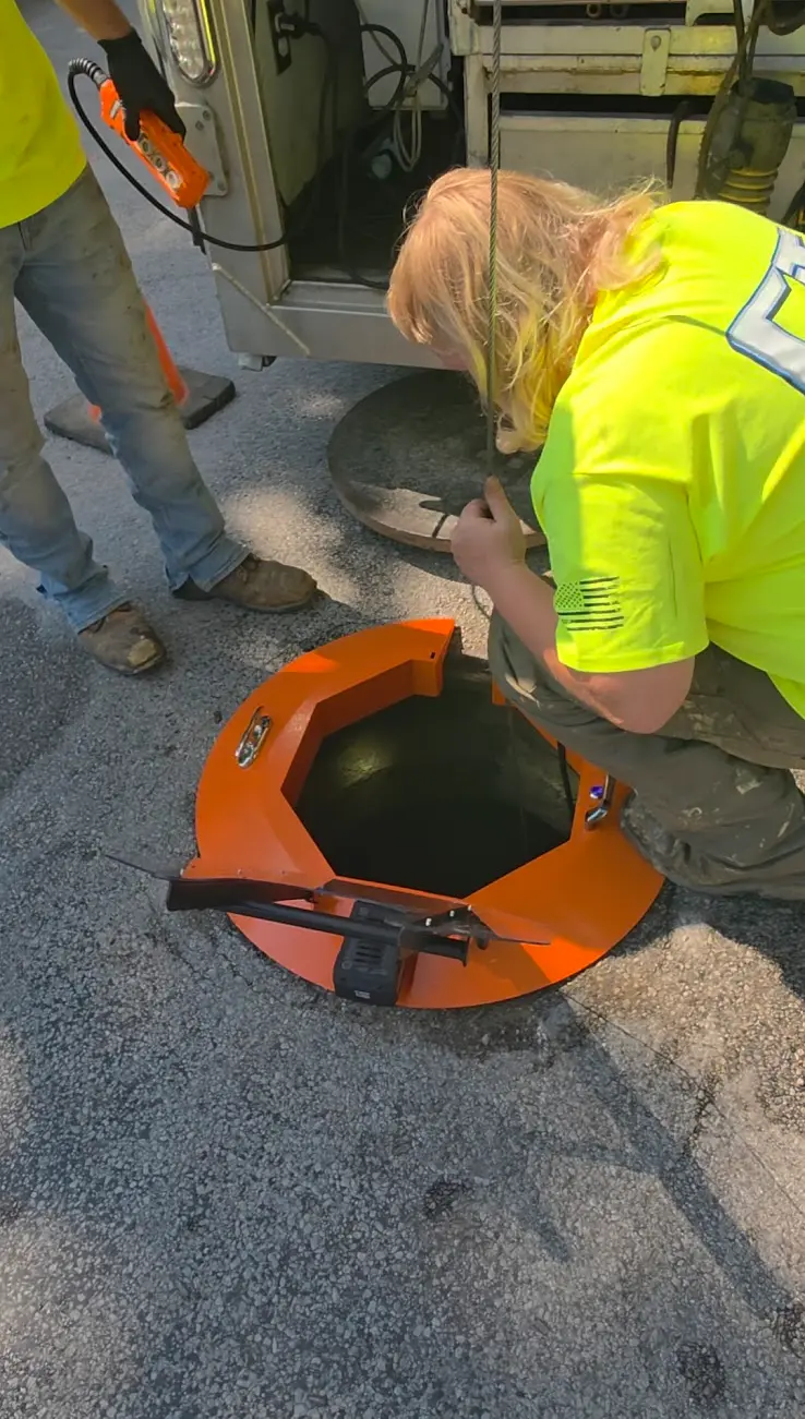 Crew using the Light Ring illuminated manhole protector during field operations