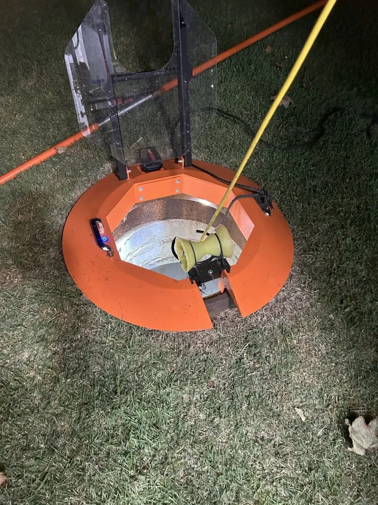 Manhole safety equipment in use with protective cover placed over an open entry.